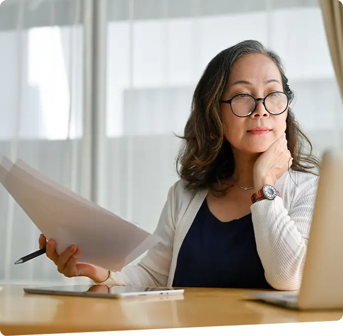 Lady looking at a laptop thoughtfully