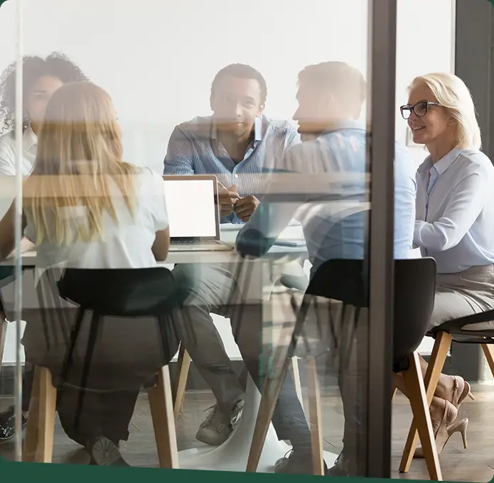 Office meeting with 5 individuals having a discussion