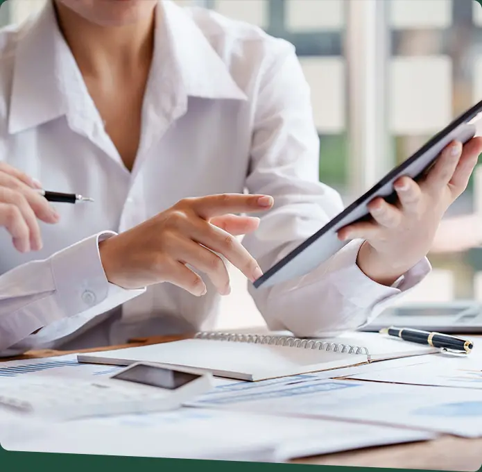 A businesswoman pointing at a tablet