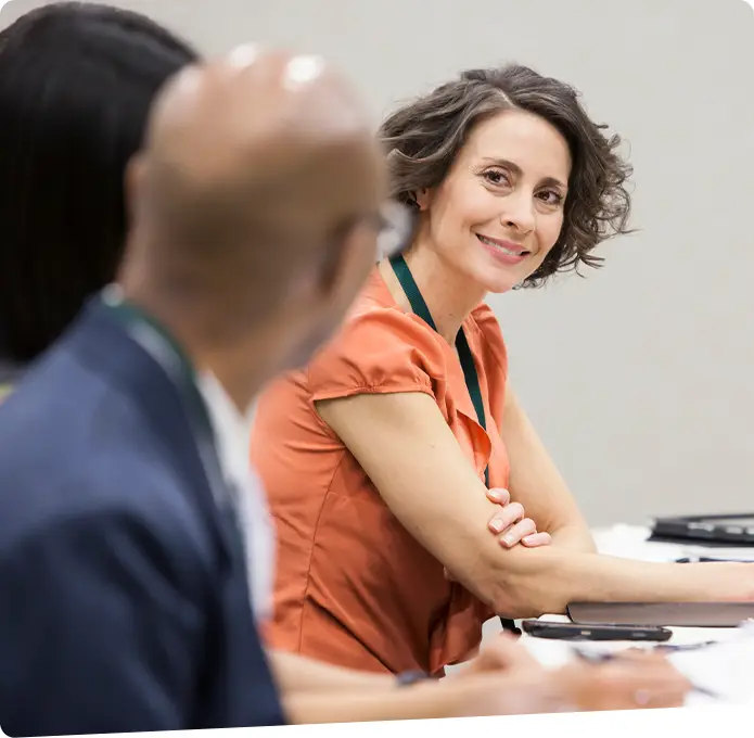 Lady smiling at a camera in an office setting