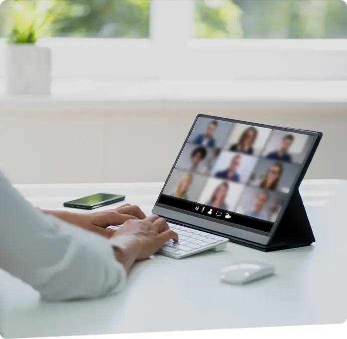An individual in a virtual meeting on a tablet