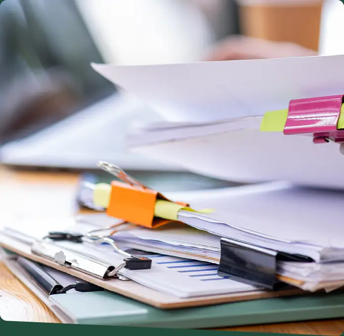 A pile of papers with clipboard and clips