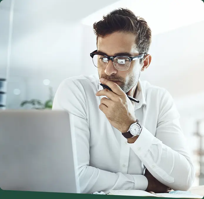 Businessman looking at a laptop thoughtfully